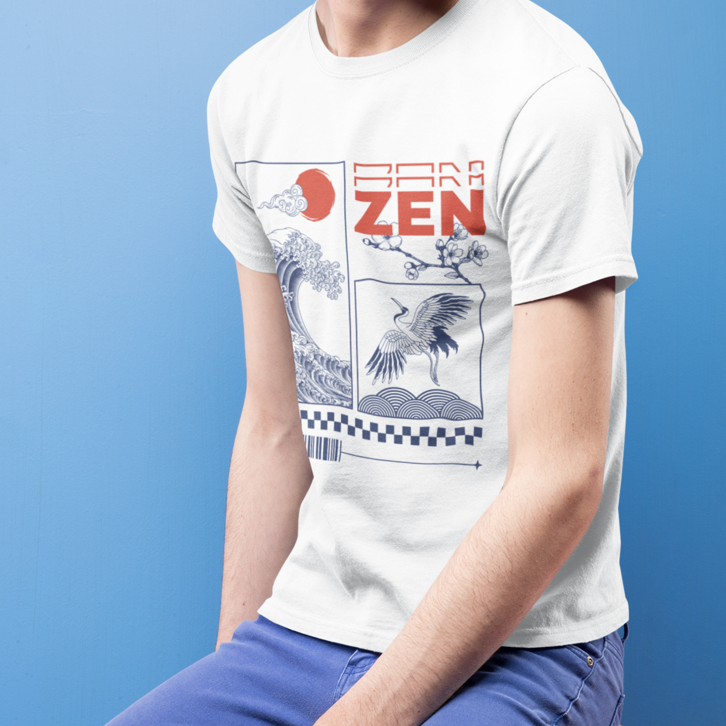 Japanese streetwear T-shirt with Zen wave and crane design, worn by man sitting against blue background.