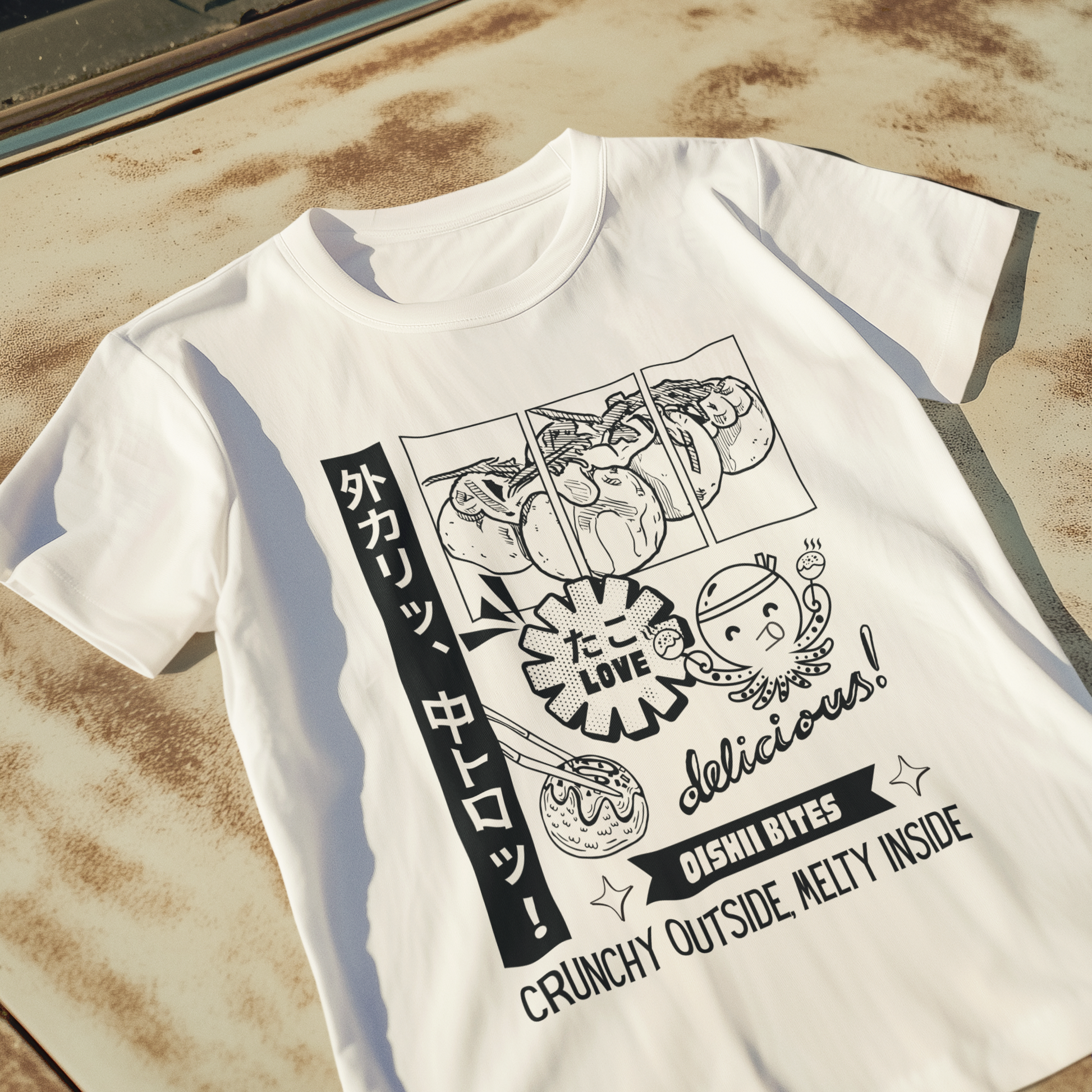 White Japanese-inspired dessert T-shirt with kawaii snack illustrations, flat lay on rustic surface.