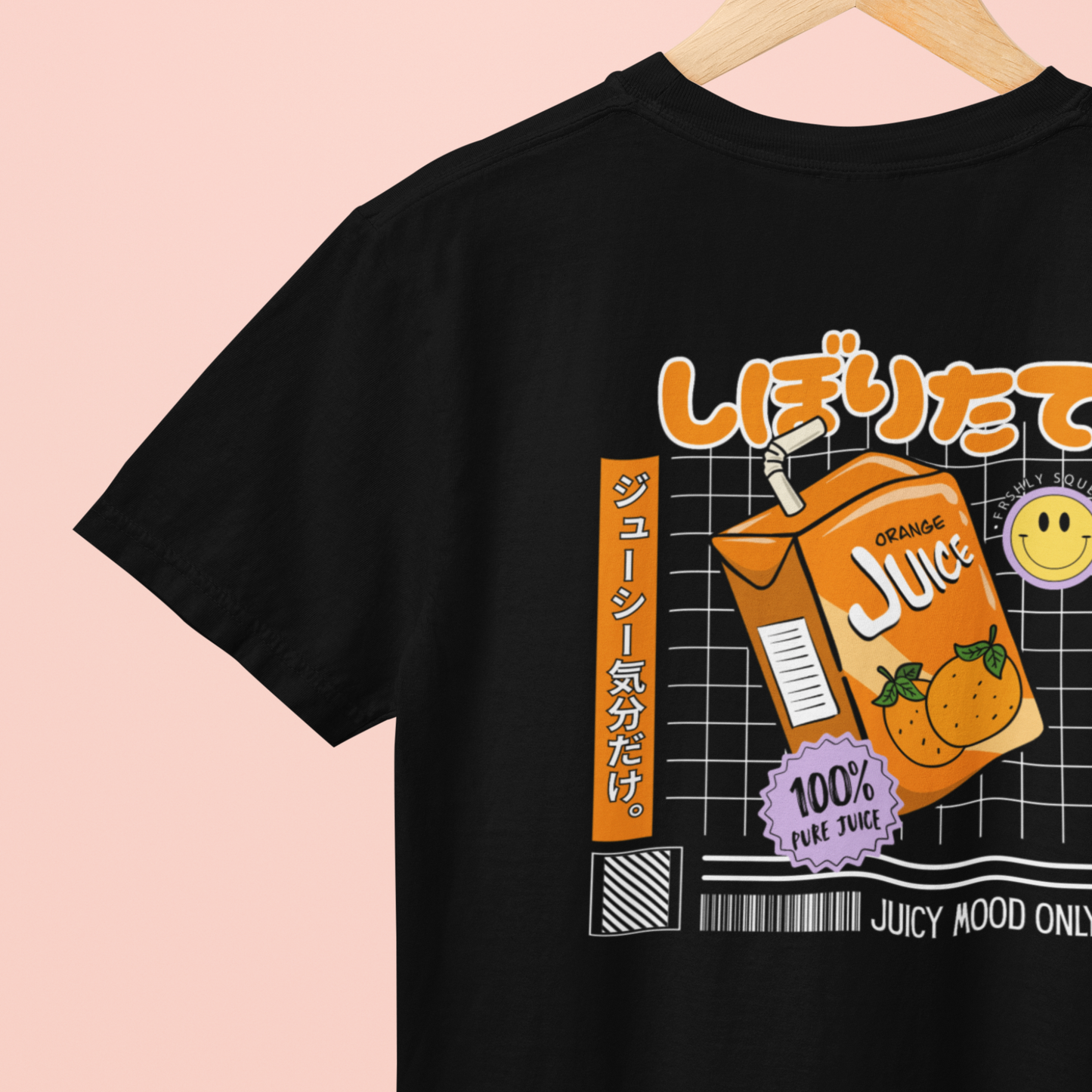 Black t-shirt with orange juice carton graphic and text on a pink background